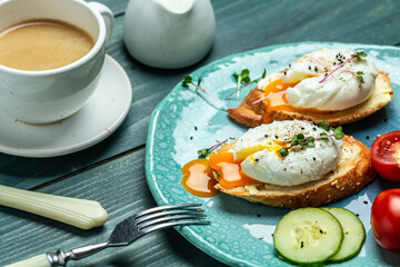 Sandwich with Poached Egg. Bread Toast sliced egg and fresh vegetable salad with cup of coffee for healthy breakfast or snack
