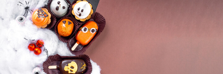 Set of Halloween sweets on black and brown background