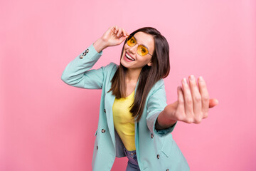 Photo portrait of cool funky girl calling you to follow isolated on pastel pink colored background