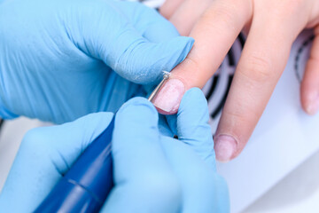 Close up Nails Polish Procedure with Professional hardware in a beauty salon