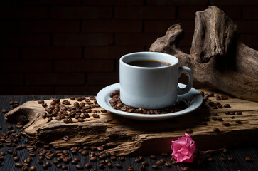 Cup of coffee on a rustic wood. Coffee grains.