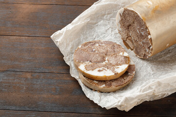 Chopped meat sausage on wooden board close up