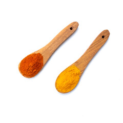 red and yellow spice in wooden spoon on white background 