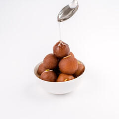 tempting Gulabjamun or gulabjaamun in a white bowl on white background