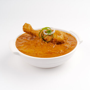 chicken masala or butter chicken main course in a white bowl on white background 