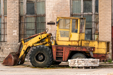 Fototapeta na wymiar Old yellow broken bulldozer