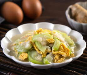 Taiwanese homemade local food of scrambled eggs with loofah gourd and sesame oil.