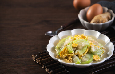 Taiwanese homemade local food of scrambled eggs with loofah gourd and sesame oil.