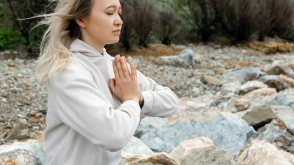 Blonde woman doing breathing pranayama exercise. Outdoor workout. Mindfulness zen spiritual...