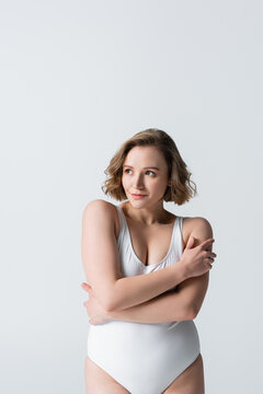 Overweight And Shy Woman With Crossed Arms Posing Isolated On White