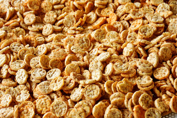 Popped Japanese brown rice is ground into powder, then made into a round disk, then crispy until golden brown and then dried. 