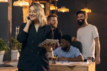 Colleagues working together in modern office using devices and gadgets during creative meeting