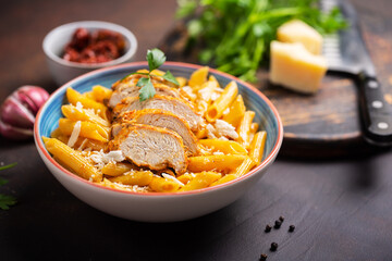 Pasta penne with cajun sauce and fried chicken