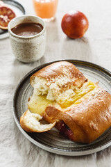 Breakfast with Twisted Bun with cheese and jam, hot chocolate, juice and oranges. Red-Jam and Cheese Danish. Selective focus