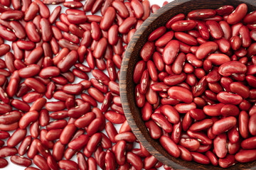 Top view of Kidney beans in wooden bowl on white background, copy space