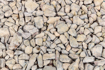 Various irregularly shaped, compacted stones as the basis for future asphalt pavement