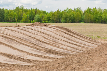 Land and building site leveling, preparation for construction, bulldozer or excavator tracks in the...
