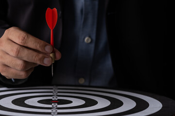 Executive marketing Businessman hand holding red arrow dart and throwing to the center of virtual...