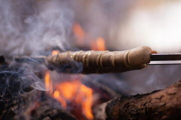 Grilled sausages. BBQ. Grilled sausages on grill with smoke and flame
