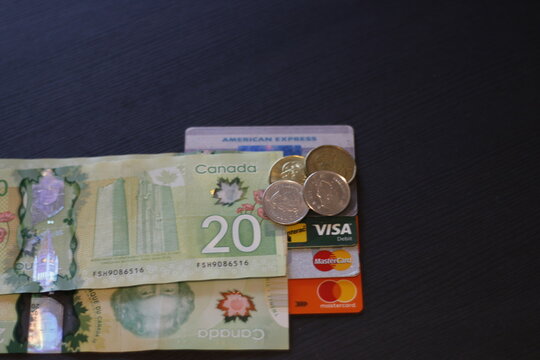London Canada, December 25 2019: Editorial image of Canadian currency and credit cards. Theme of debt and spending