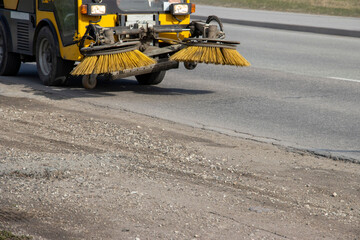 Asphalt road. Selective focus .Industry Cleaning Machine, road cleaner with brushes  moving on the...