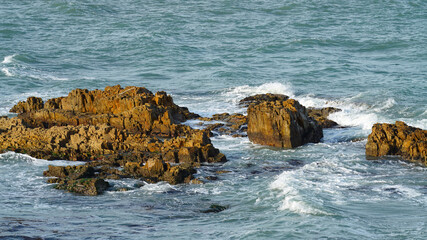 The rock beaches of the sea, where the waves swirled.