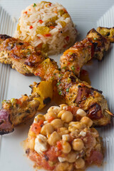 Chicken Kabobs. Cubes of grilled chicken, grilled vegetables, onions bell peppers and seasoned with garlic and spices. Served with rice, traditional classic Greek or Italian restaurant favorite. 