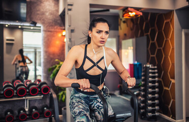 Obraz na płótnie Canvas Woman cycling workout in gym.