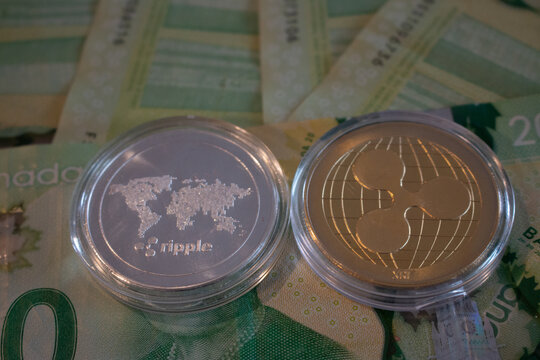 London Canada, January 24 2020: Editorial Illustrative photo of Ripplecoin crypto currency on top of canadian currency