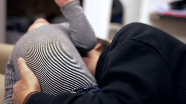 Mother tickling baby toddler child. Candid authentic mom tickles kid