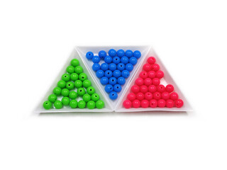 Photo background of round acrylic colored beads in three triangular packages on a white background