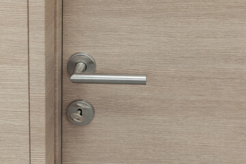 wooden room door with metal handle