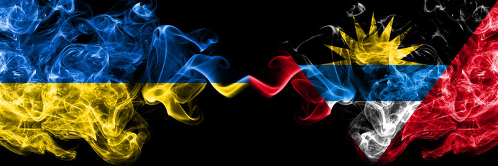 Ukraine, Ukrainian vs Antigua and Barbuda, Antiguan and Barbudan smoky mystic flags placed side by side. Thick colored silky abstract smokes flags.