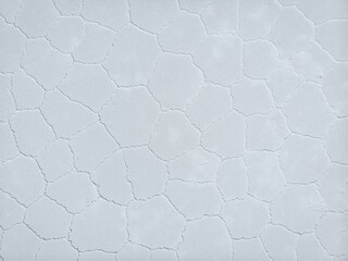 Aerial top down view of hexagonal shaped salt flat pattern structure of Salar de Uyuni lake Potosi...