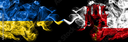 Ukraine, Ukrainian vs British, Britain, Gibraltar smoky mystic flags placed side by side. Thick colored silky abstract smokes flags.