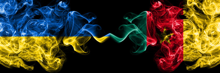 Ukraine, Ukrainian vs Cameroon, Cameroonian smoky mystic flags placed side by side. Thick colored silky abstract smokes flags.