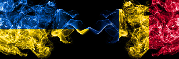 Ukraine, Ukrainian vs Chad, Chadian smoky mystic flags placed side by side. Thick colored silky abstract smokes flags.