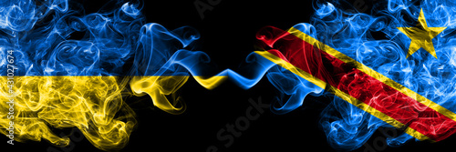 Ukraine, Ukrainian vs Democratic Republic of the Congo smoky mystic flags placed side by side. Thick colored silky abstract smokes flags.