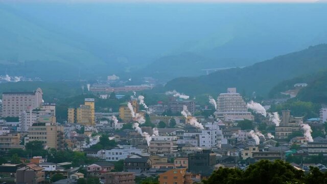 Beppu, Japan. An evening in a resort town of Beppu, Japan, with a view of mountains embracing the city full of hot steams