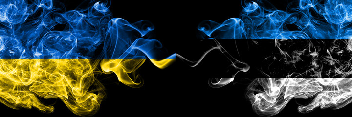 Ukraine, Ukrainian vs Estonia, Estonian smoky mystic flags placed side by side. Thick colored silky abstract smokes flags.