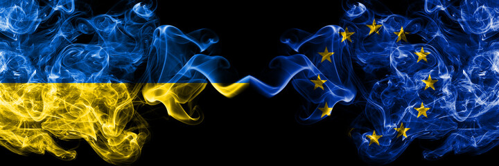 Ukraine, Ukrainian vs Europe, European, European Union smoky mystic flags placed side by side. Thick colored silky abstract smokes flags.