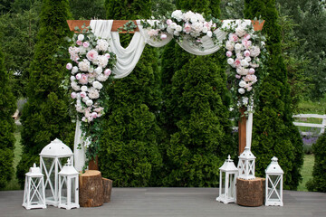 Arch for the wedding ceremony, decorated with cloth and white flowers