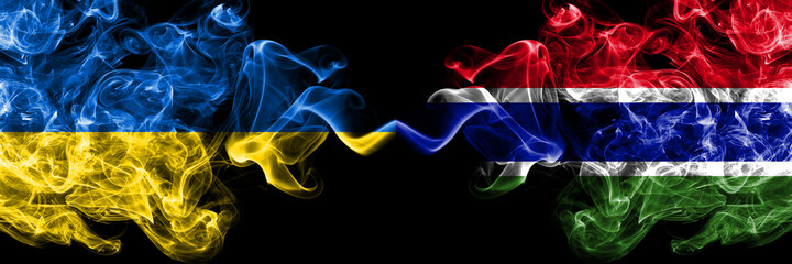 Ukraine, Ukrainian vs Gambia, Gambian smoky mystic flags placed side by side. Thick colored silky abstract smokes flags.