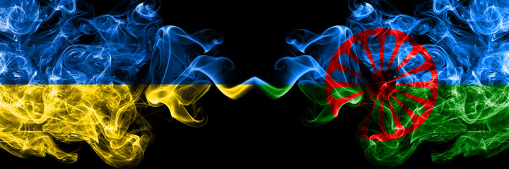Ukraine, Ukrainian vs Gipsy smoky mystic flags placed side by side. Thick colored silky abstract smokes flags.