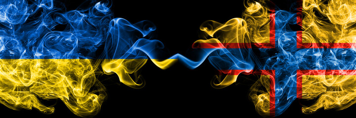 Ukraine, Ukrainian vs Ingrian people smoky mystic flags placed side by side. Thick colored silky abstract smokes flags.