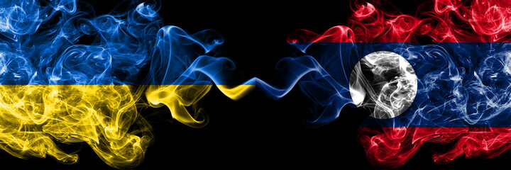 Ukraine, Ukrainian vs Laos smoky mystic flags placed side by side. Thick colored silky abstract smokes flags.