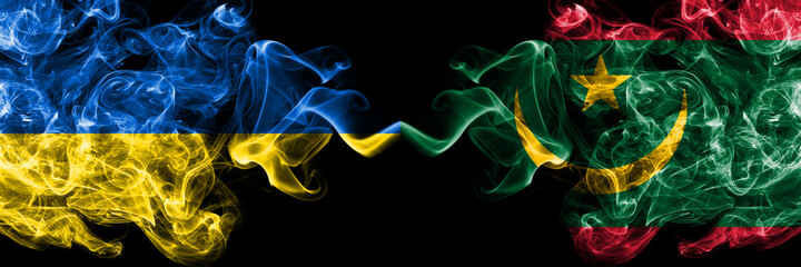 Fototapeta premium Ukraine, Ukrainian vs Mauritania smoky mystic flags placed side by side. Thick colored silky abstract smokes flags.