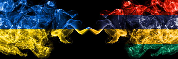 Ukraine, Ukrainian vs Mauritius smoky mystic flags placed side by side. Thick colored silky abstract smokes flags.