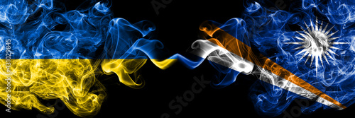 Ukraine, Ukrainian vs Marshall Islands smoky mystic flags placed side by side. Thick colored silky abstract smokes flags.