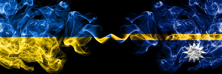 Ukraine, Ukrainian vs Nauru, Nauruan smoky mystic flags placed side by side. Thick colored silky abstract smokes flags.